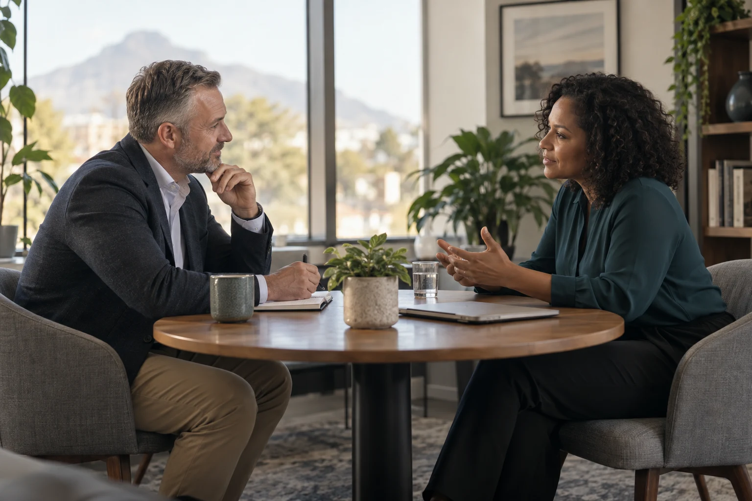 A professional listening thoughtfully to a client in a light-filled office